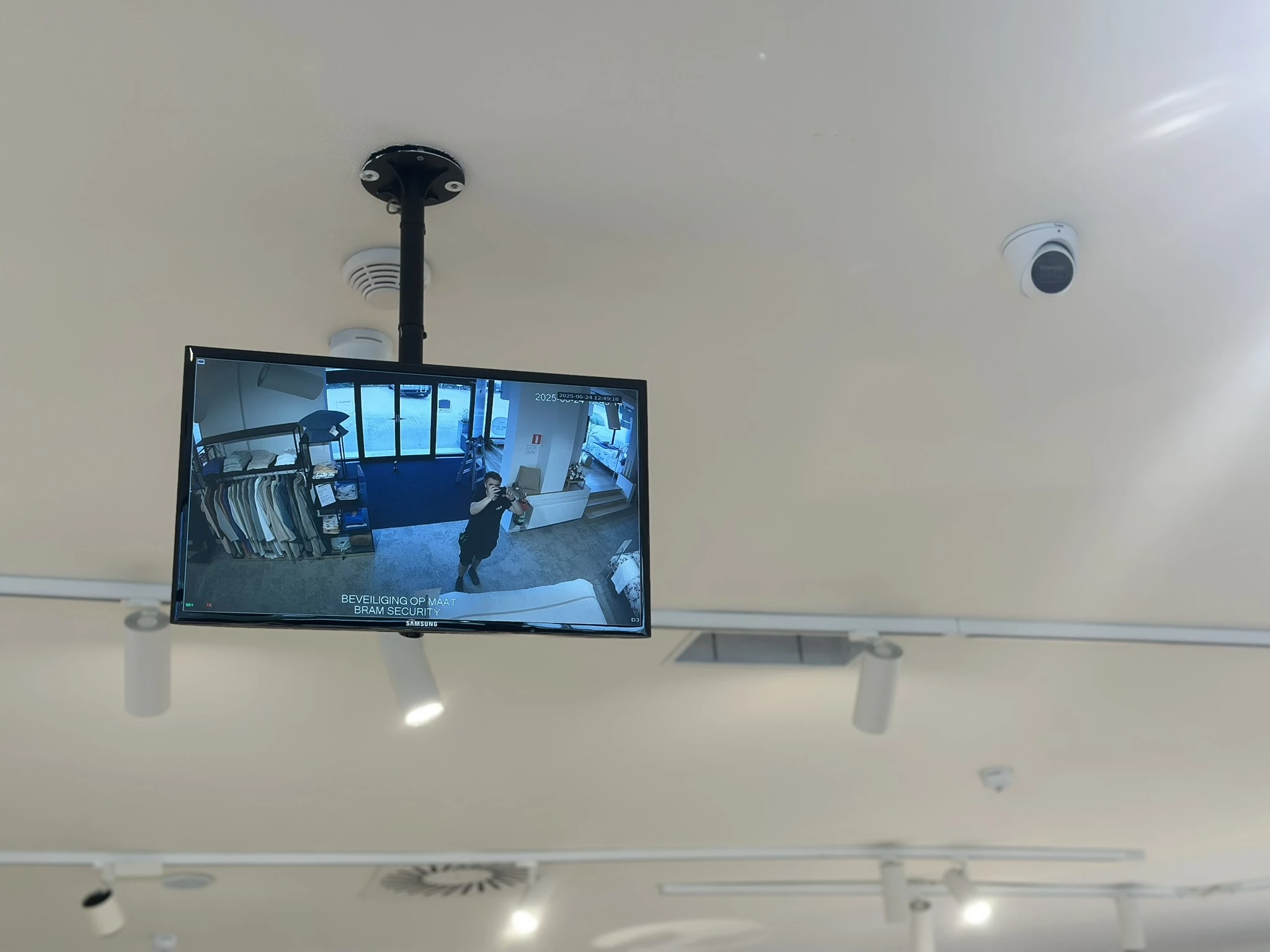 Beveiligingsmonitor met live camerafeed in showroom, Bram Security in Nazareth.